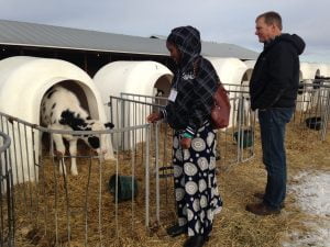 Martha Bone, a Kenyan partner, and Foodgrains Bank Alberta Regional Coordinator, Terrance Barg visit the calves at the dairy farm.  Photo: Suzanne Rumsey
