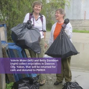 Photo: Valerie Maier (left) and Betty Davidson (right) collect recyclables in Dawson City, Yukon, that will be returned for cash and donated to PWRDF.